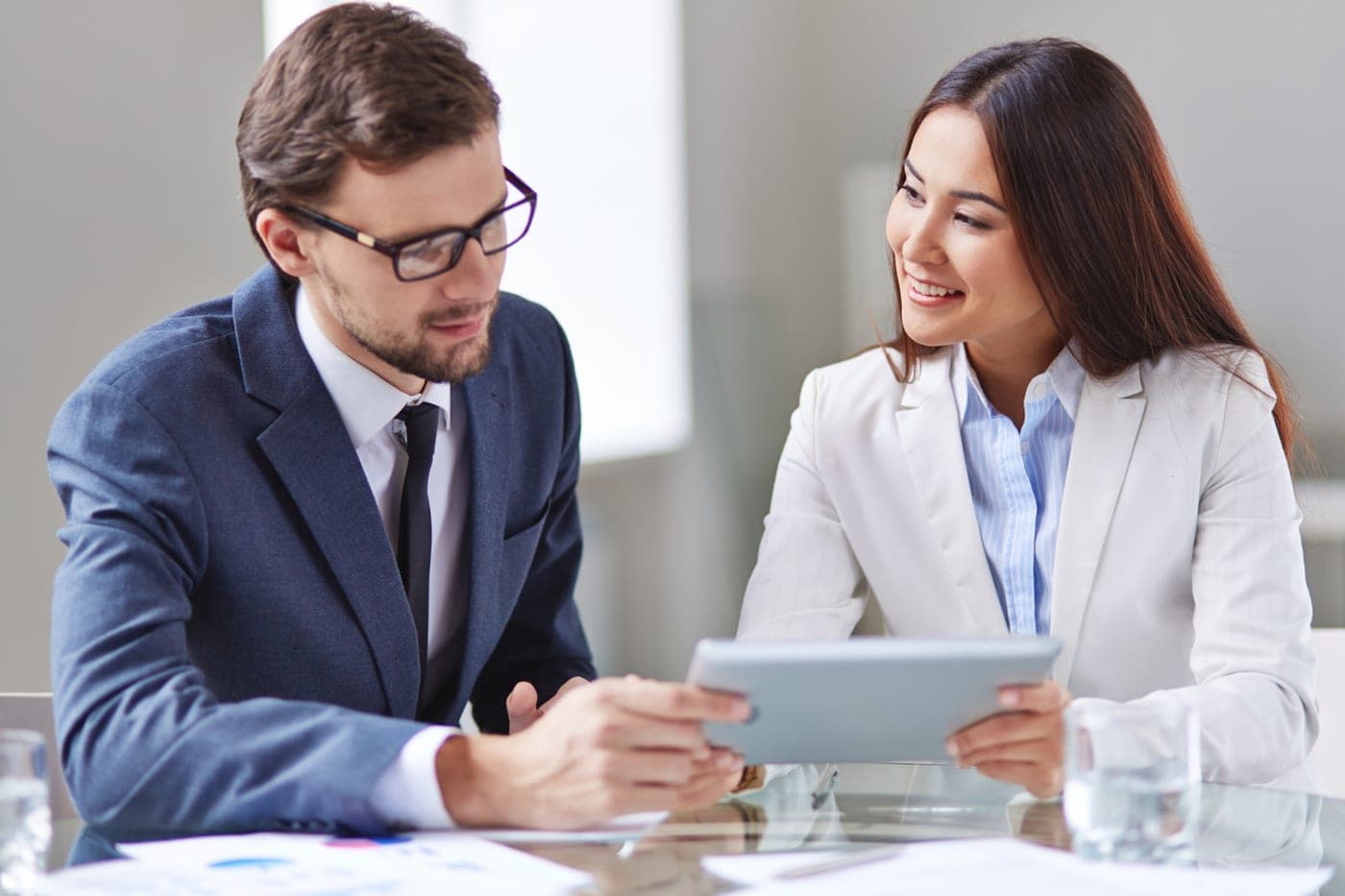 Consultant walking a client through findings on a tablet